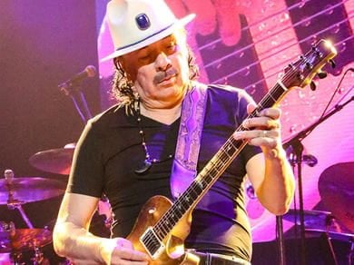 Carlos Santana playing guitar on stage