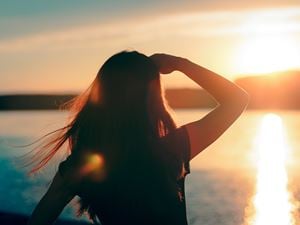 woman looking at sunset