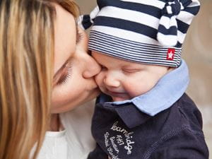 baby kissed by mom