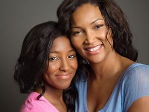 mom hugging teen daughter