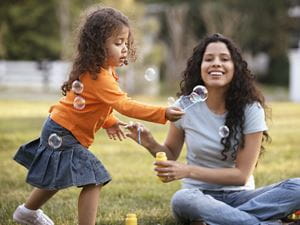 mother daughter play bubbles