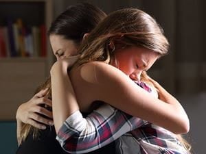 friends crying hugging