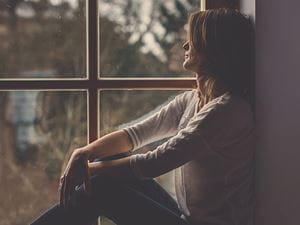 Woman looking out of a window