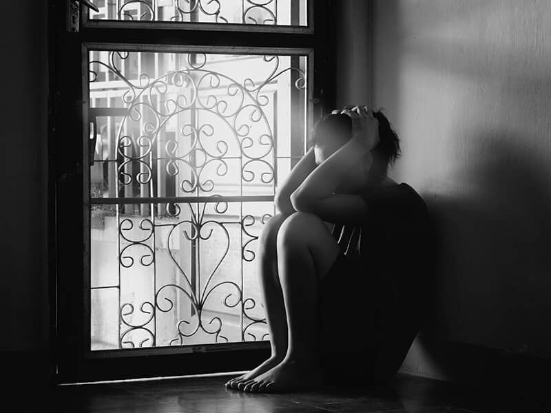 depression sad woman light door credit shutterstock