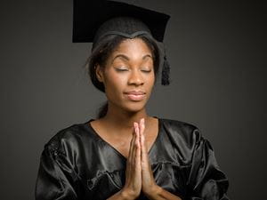 Praying college grad