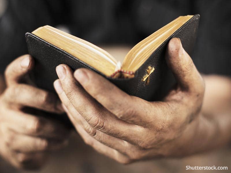 christian-man-reading-bible-prayer-hands