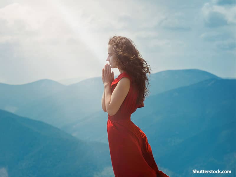 woman praying mountain