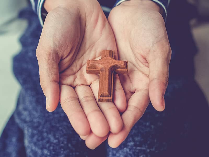 hands holding cross