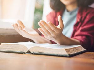 Woman Praying With Bible