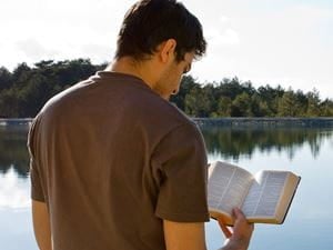 man reading Bible