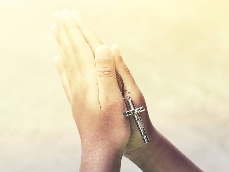 hand holding rosary