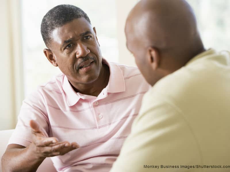 men talking in living room