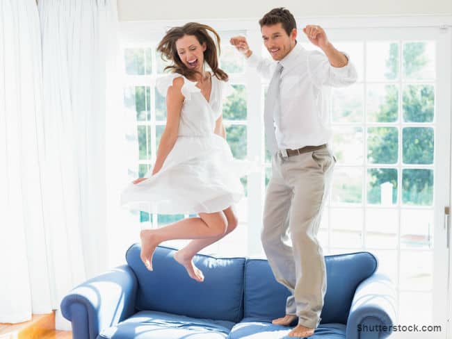 Couple Jumping on Couch