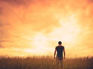 man standing sunset