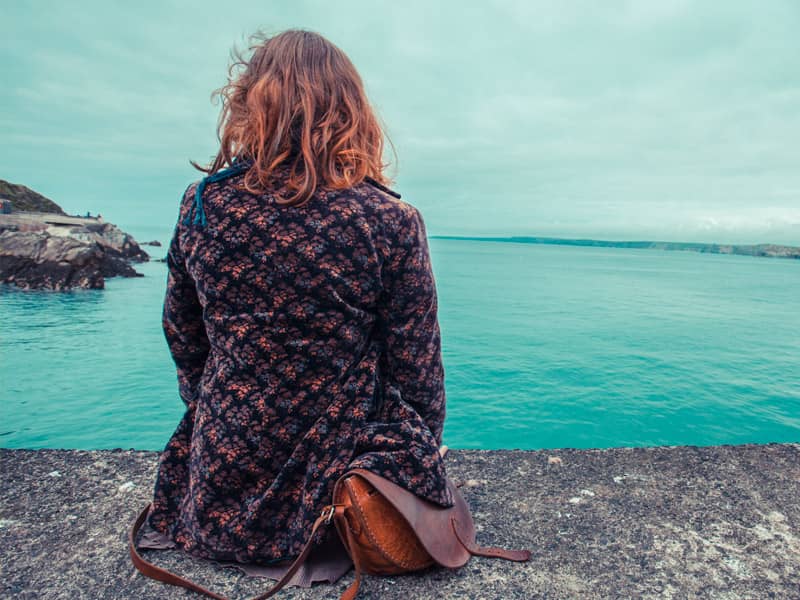 woman depressed looking at ocean