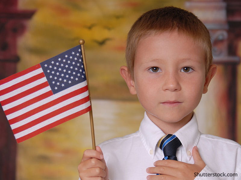 child-holding-flag-serious