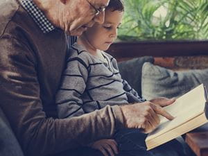 grandad reading to grandson