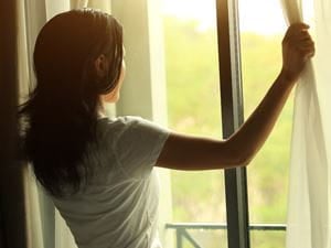 Woman Looking Out Window