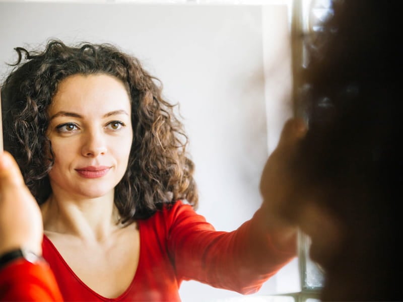 Woman looking in mirror