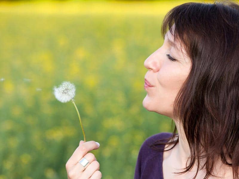 woman-blowing-dandelion-nature