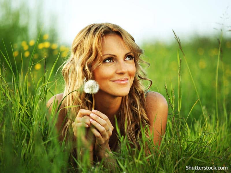 woman-dandelion-laying-in-grass