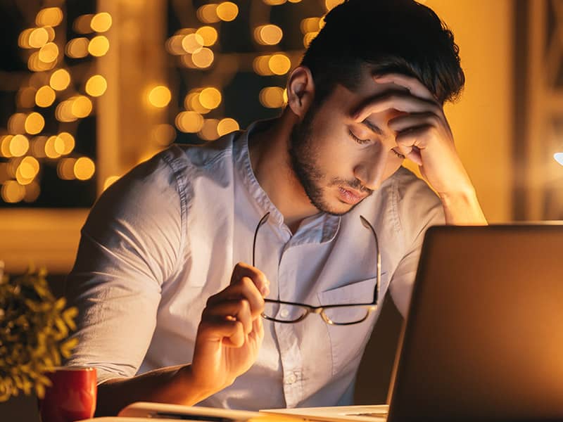 man stressed computer night 