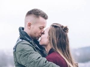 man and woman embrace closely