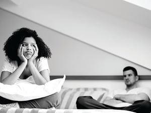 Couple fighting in bed