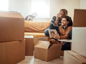 couple unpacking moving boxes