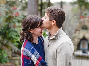 Man kissing woman's forehead 