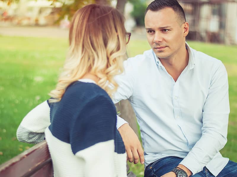 relationships-couple-talking-serious-park-outside