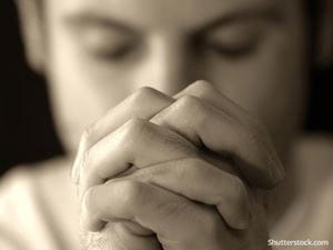 man-praying-sepia