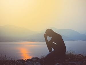 praying and reflecting at shore