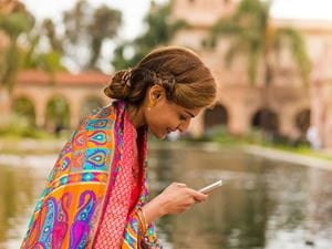 Woman in bright shawl with phone