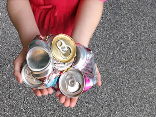 Hand holding crushed aluminum cans