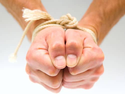 Hands bound with rope