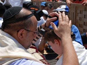 Jewish man and child bar mitzvah at western wall