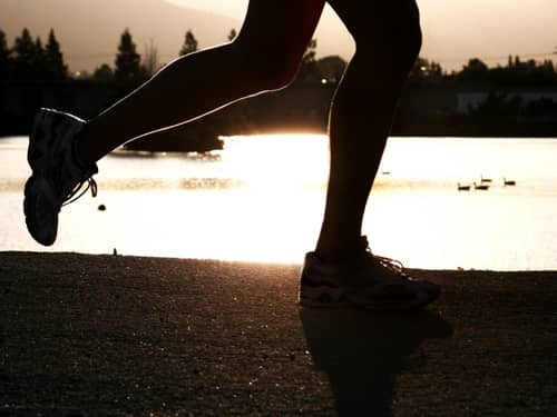 Woman's legs running on the beach.