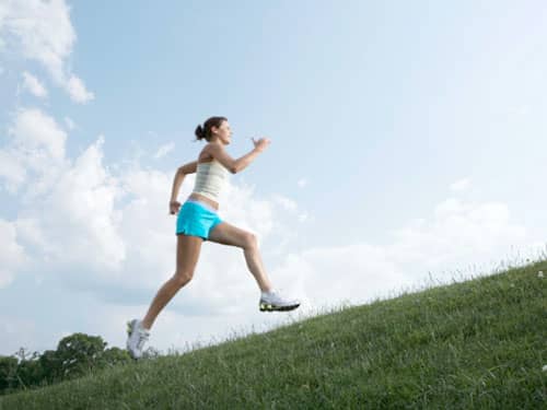 Woman sprinting uphill