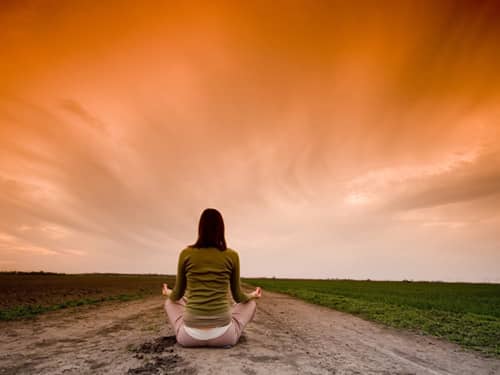 Woman meditate sunset