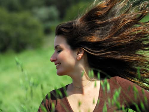 Woman in a breezy meadow