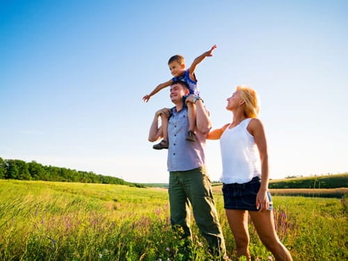 Healthy family walking in a field