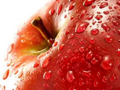 A close up of a wet apple
