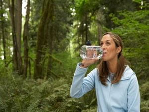 Woman drinking water on a hike