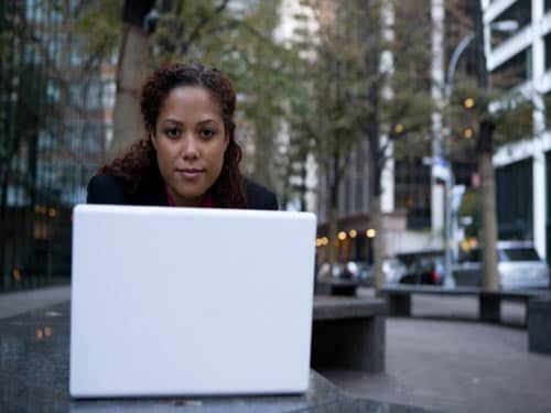 Woman on laptop in the city