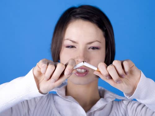 Woman breaking a cigarette