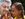Grandmother and granddaughter listening to a cell phone