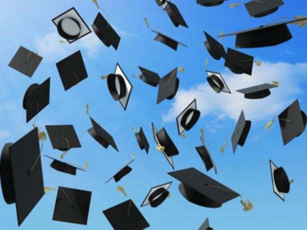 Graduate caps in the air