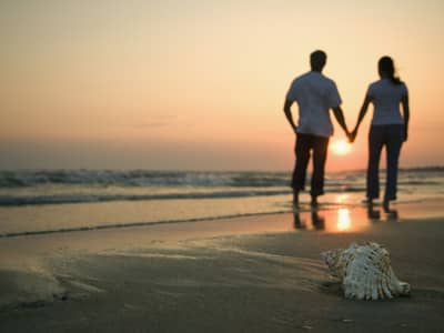 Couple holding hands on a beach