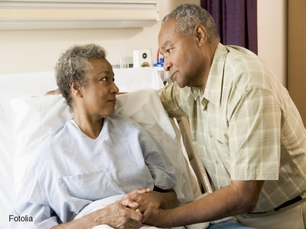 Man visiting woman in hospital